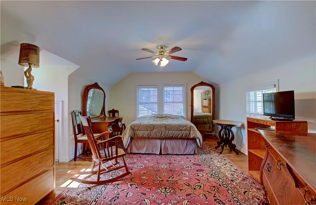 Bedroom featuring light wood-type flooring, vaulted ceiling, and ceiling fan