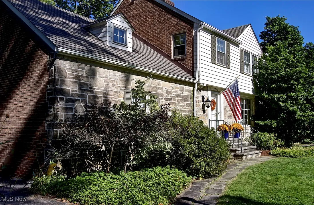 View of side of home featuring stone siding