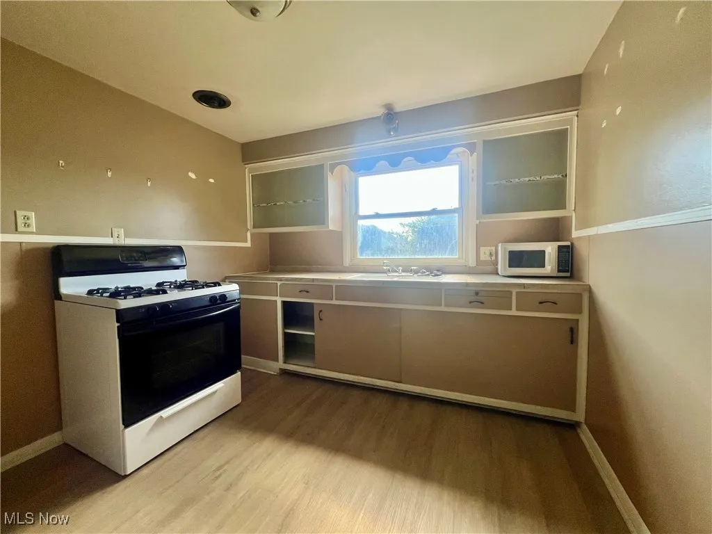 Kitchen featuring range with gas cooktop and light wood finished floors