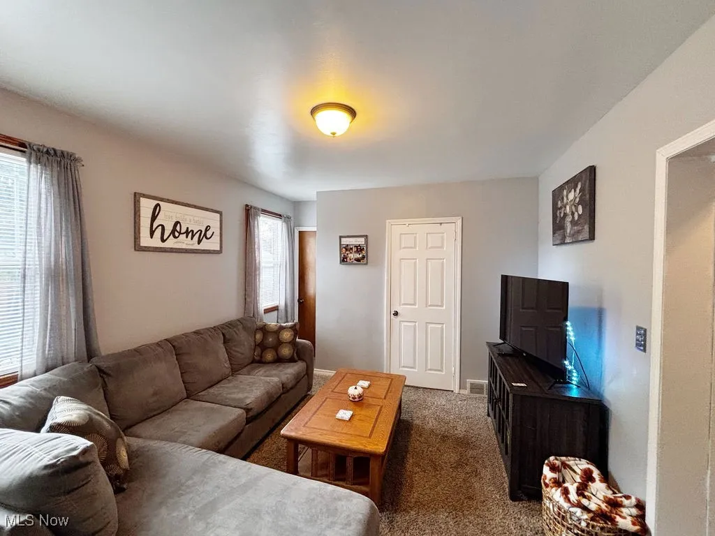 Living area with carpet floors and baseboards