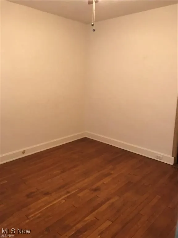 Empty room featuring dark wood-style floors