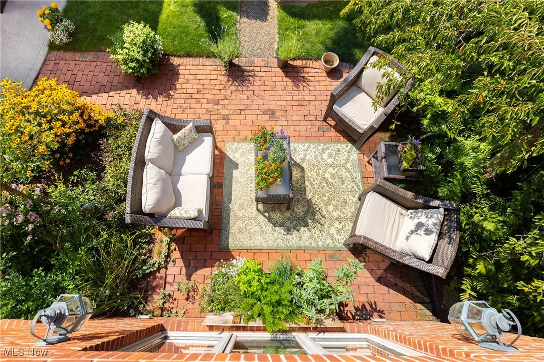 This stunning yard provides a brick patio and gorgeous gardens!