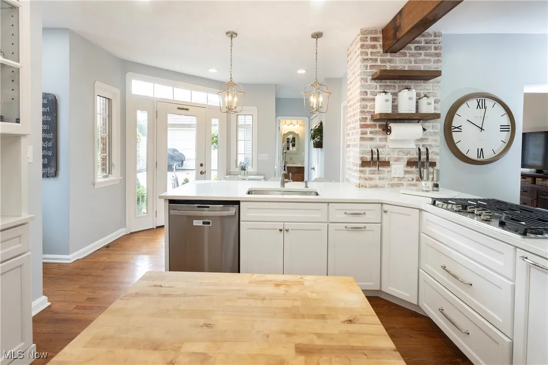 Don't miss the wood beam, whitewashed brick and the pendant lighting!