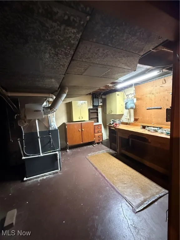 Unfinished basement with a workshop area
