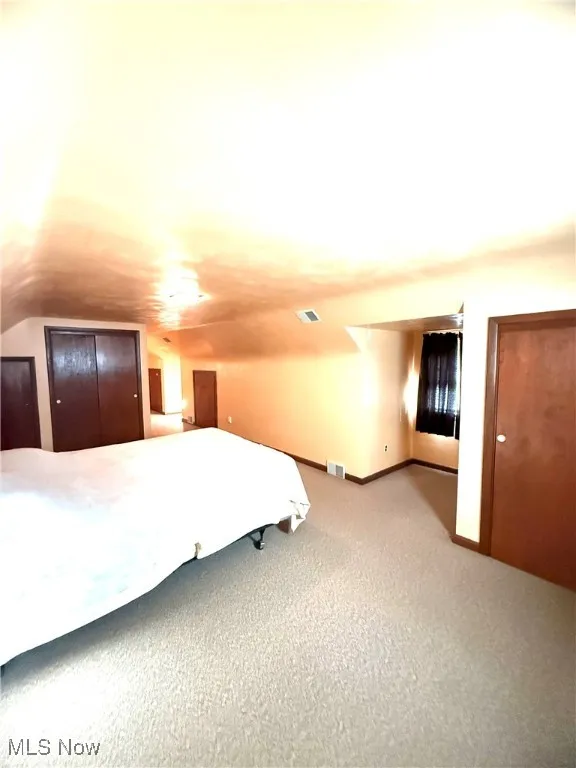 Unfurnished bedroom with carpet and baseboards