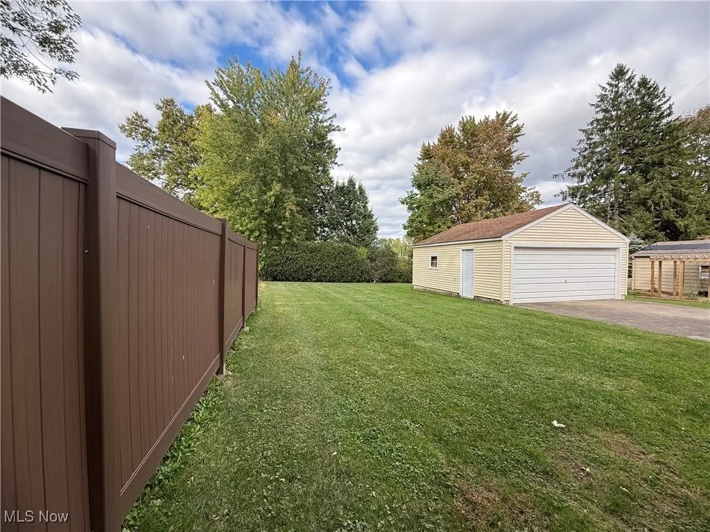 View of yard with an outbuilding and a garage