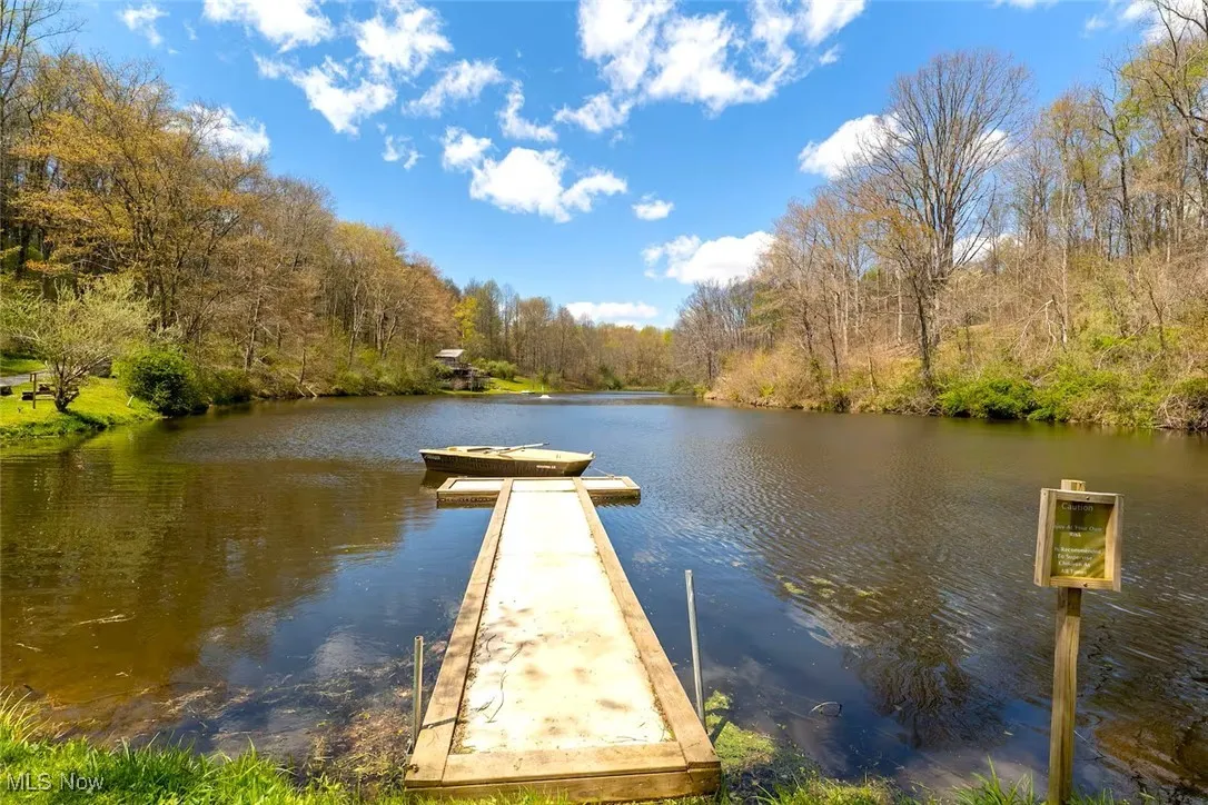 Dock featuring a forest view and a water view