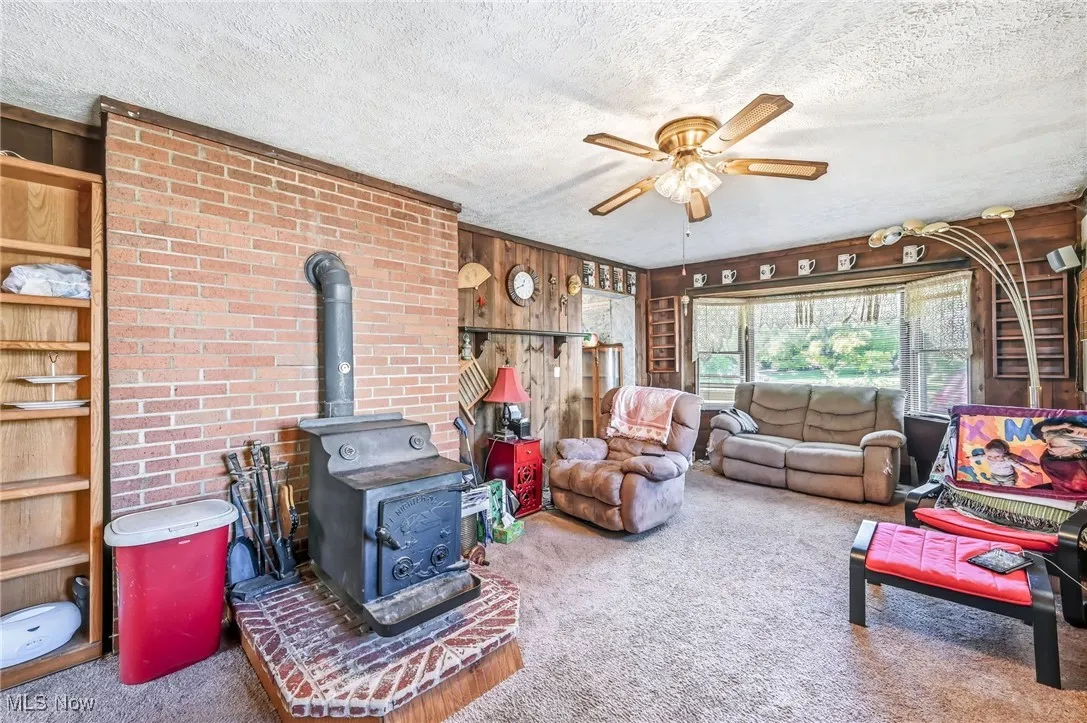 wood burner and bay window with carpet flooring