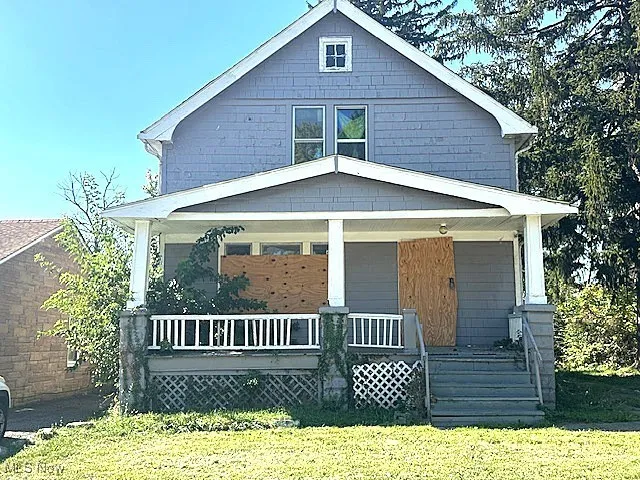 View of front of home with a porch and a front yard