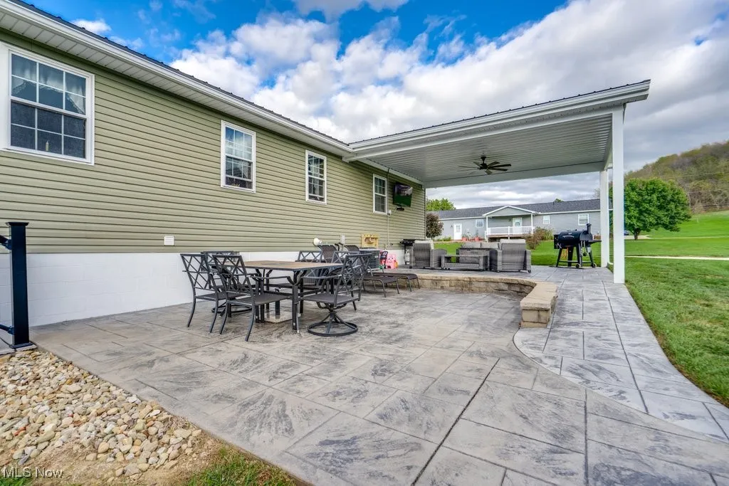 View of patio with a ceiling fan, area for grilling, and outdoor dining space