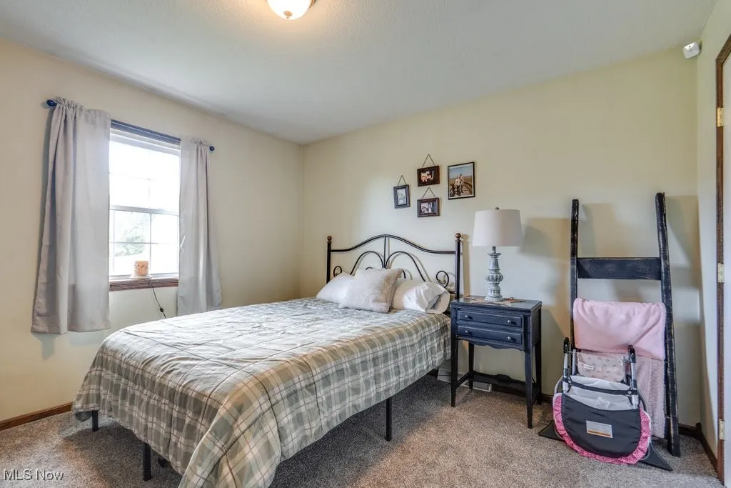Carpeted bedroom featuring baseboards