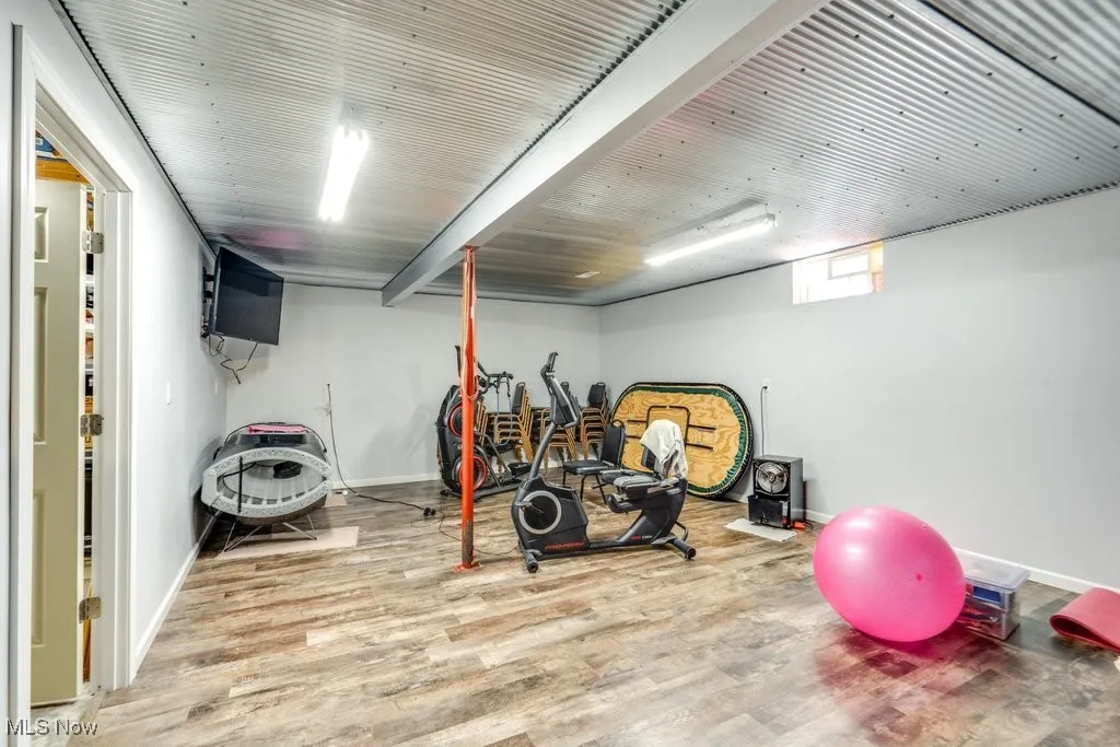 Workout area featuring wood finished floors and baseboards