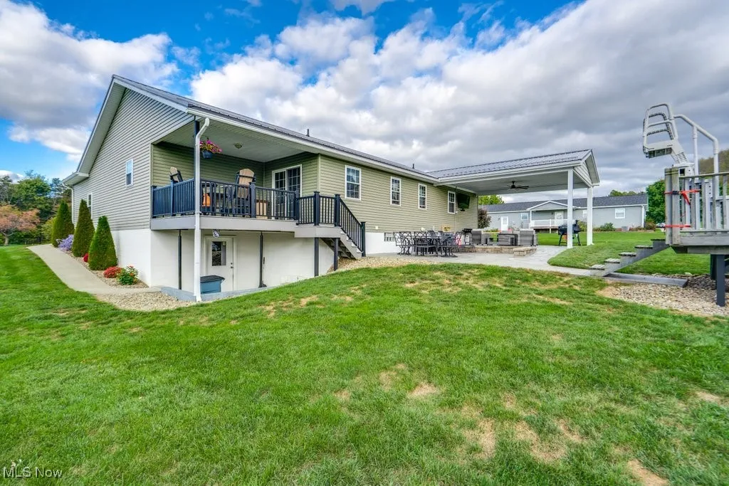 Back of property featuring a patio, stairs, a yard, a ceiling fan, and a wooden deck