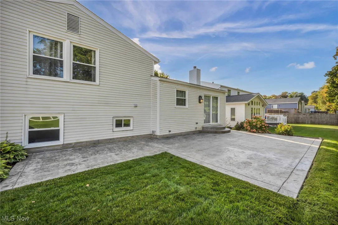 Back of house featuring a patio area and a chimney