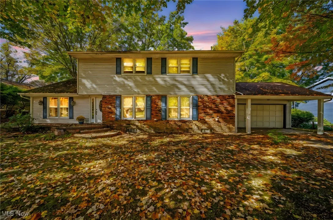 View of front of home featuring a garage and brick siding