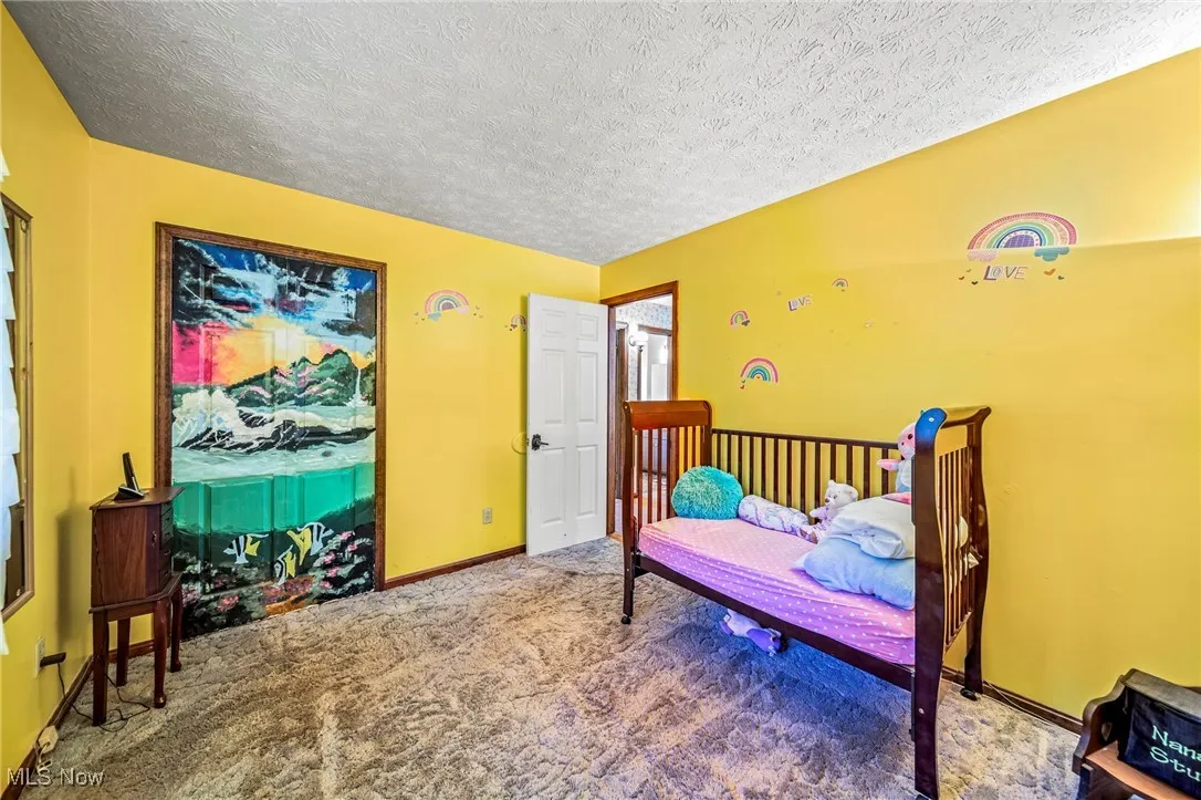 Bedroom with carpet and a textured ceiling