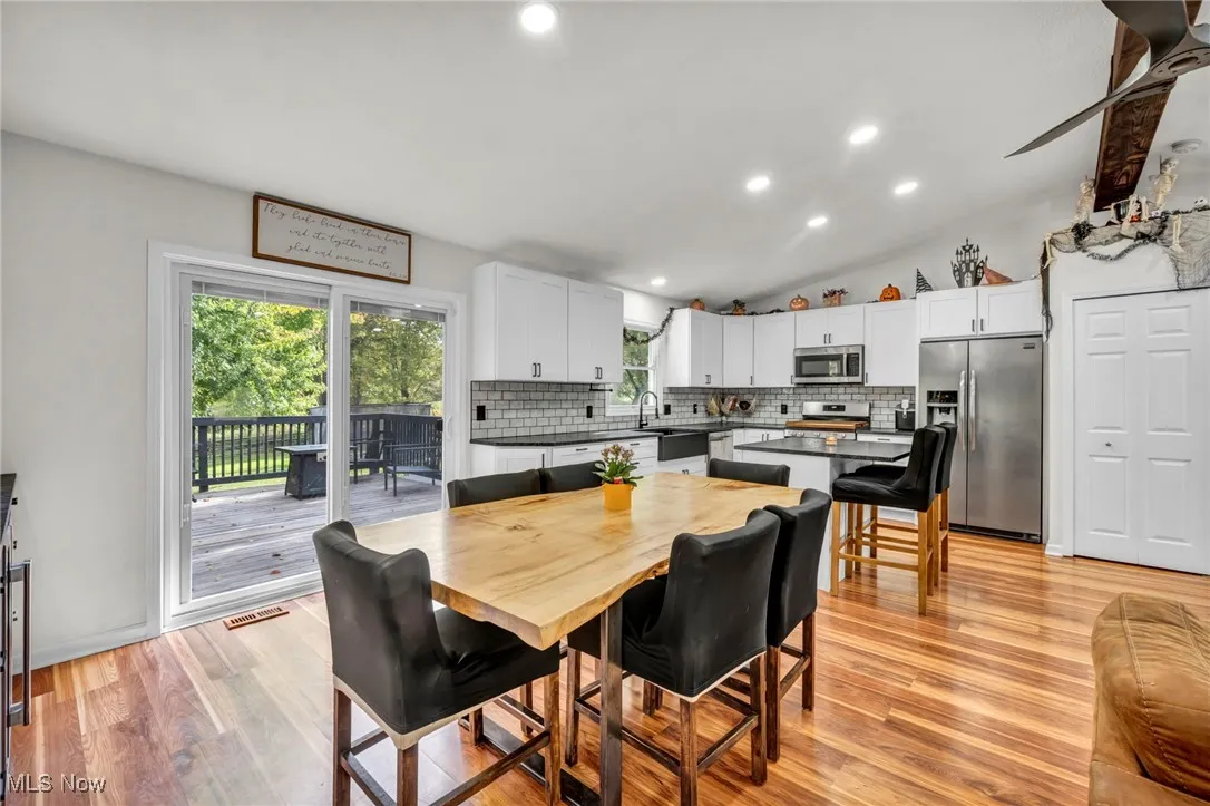 Dining space featuring recessed lighting, light wood finished floors, and lofted ceiling