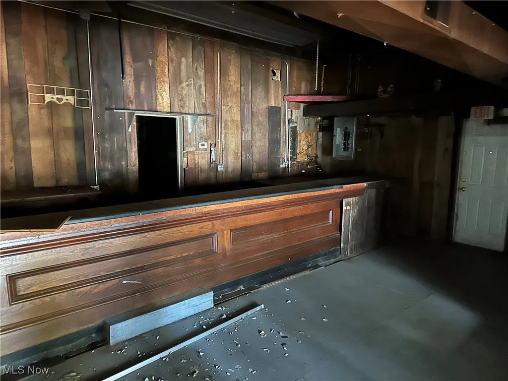 Bar area featuring electric panel and panel walls