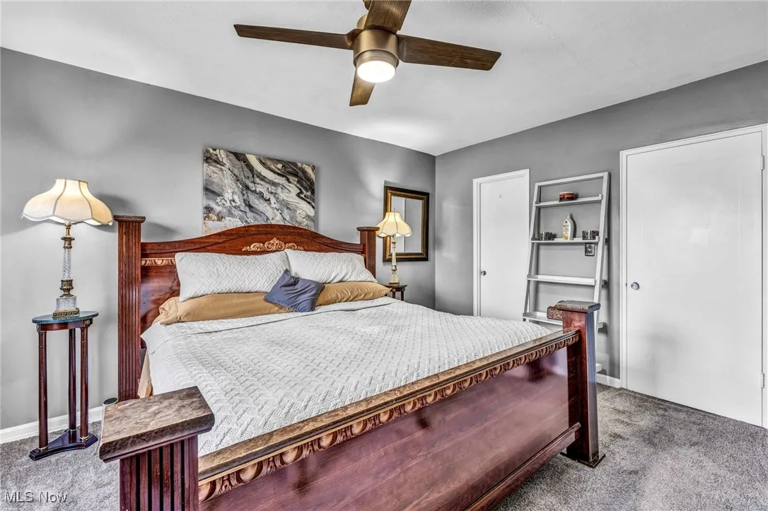Carpeted bedroom with ceiling fan