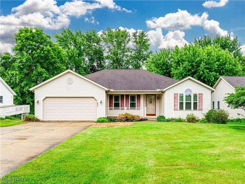 Ranch home featuring a front porch, front yard and a 2 car garage