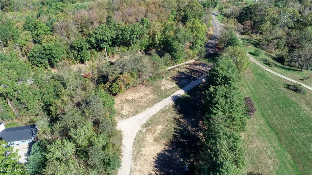 Aerial overview of property's location featuring a heavily wooded area