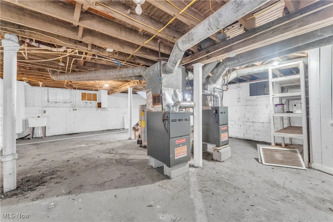 Unfinished below grade area with heating unit and water heater