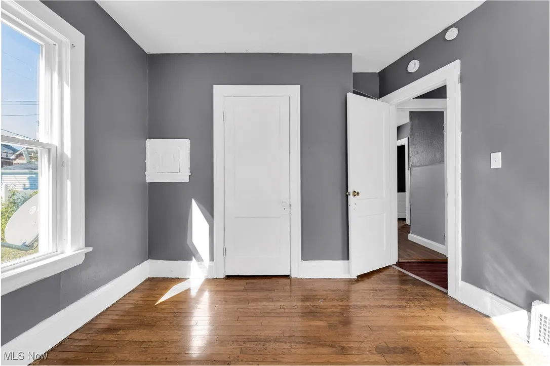Unfurnished bedroom with hardwood / wood-style flooring and a closet