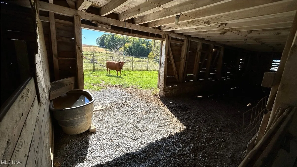 View of patio with an outbuilding, an exterior structure, and a rural view