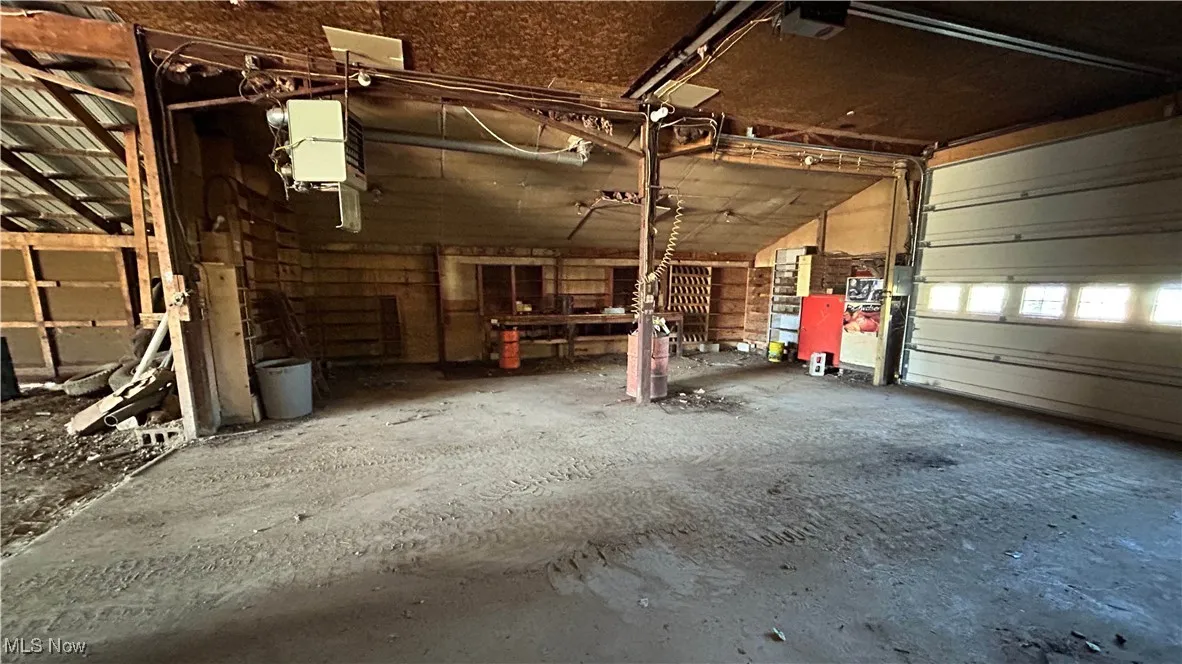 Garage featuring a heating unit and a garage door opener