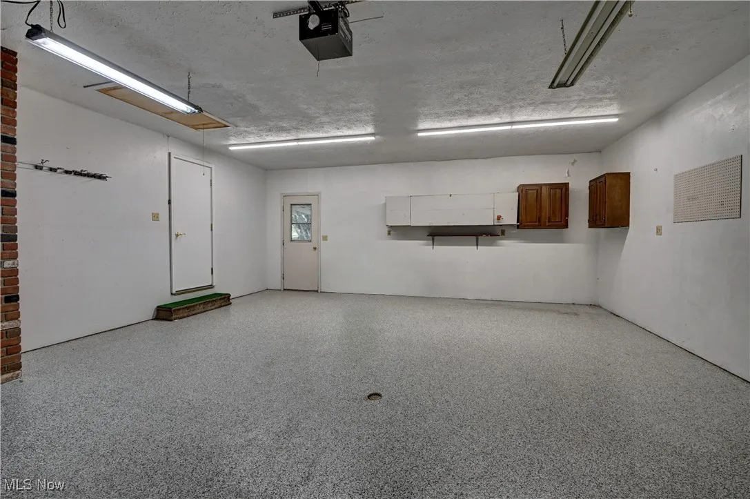 Garage featuring a garage door opener
