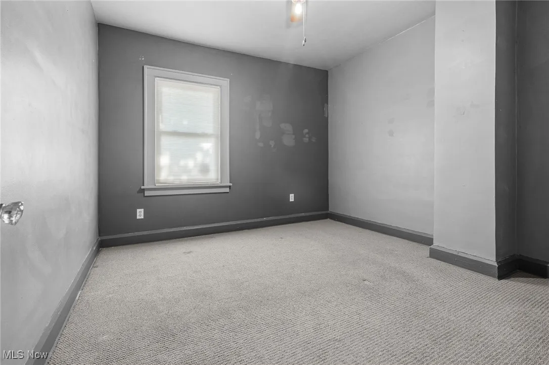 Carpeted spare room with baseboards