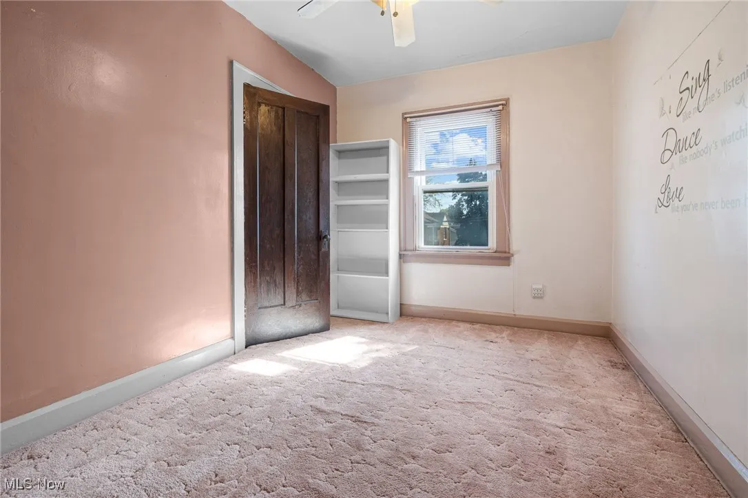 Unfurnished bedroom featuring carpet and ceiling fan