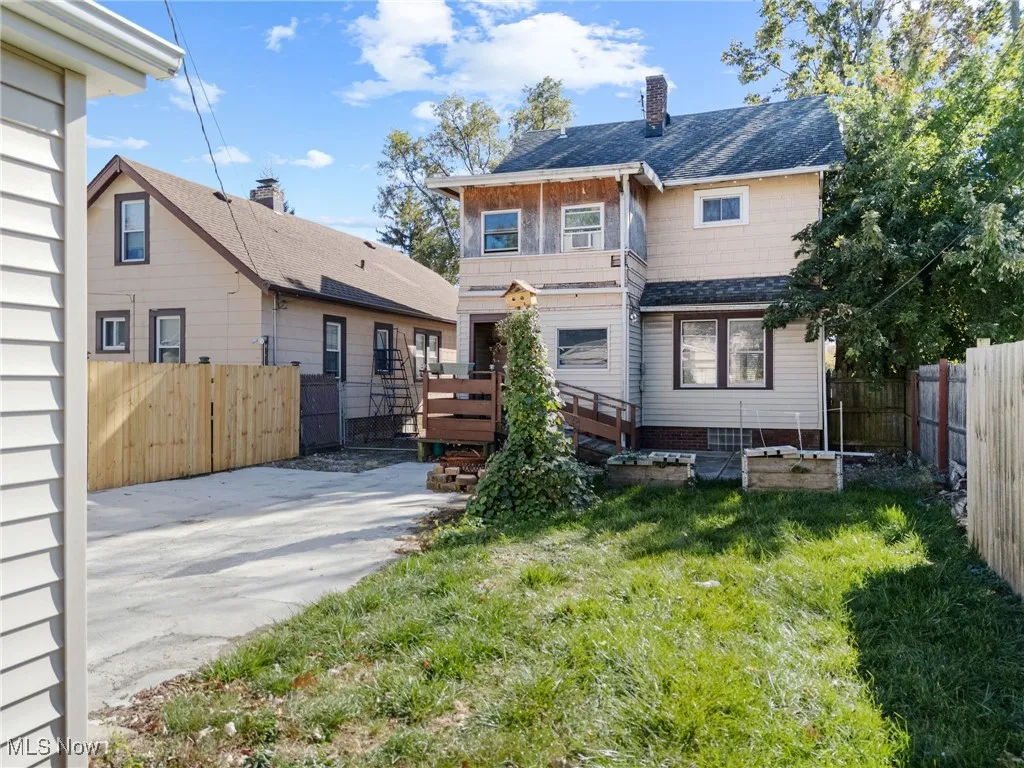 Rear view of house featuring a fenced backyard, a patio area, a shingled roof, a chimney, and a deck