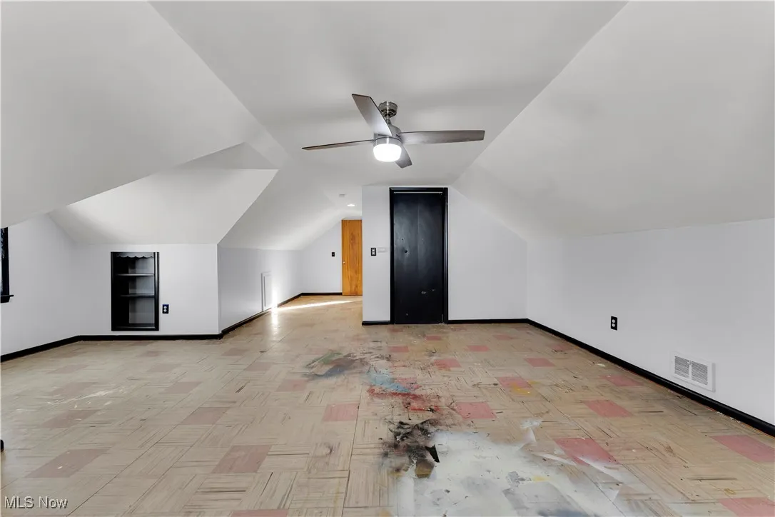 Bonus room with vaulted ceiling and ceiling fan