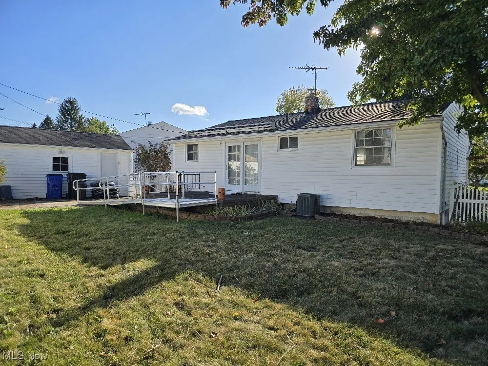 Rear view of property featuring a lot of room to Enjoy.  Ramp has been contracted for removal.