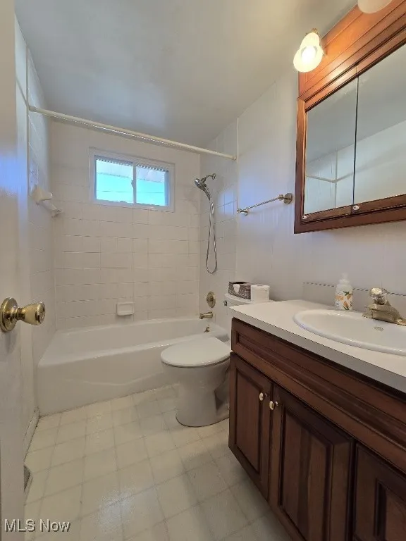 Bathroom featuring shower / tub combination and vanity.