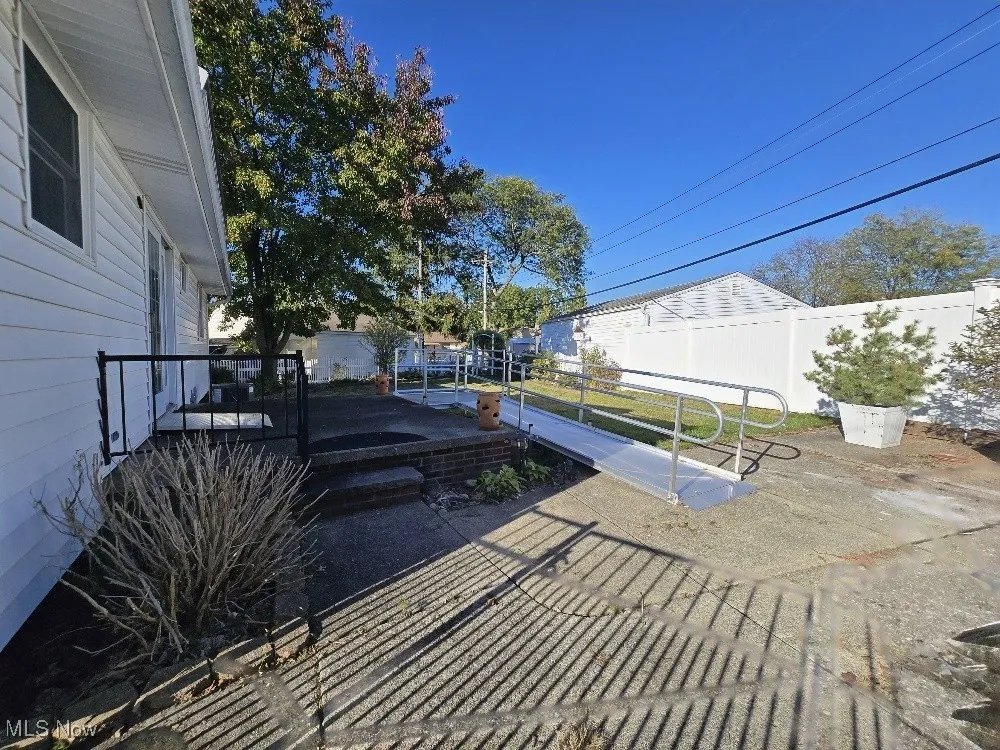 Fenced backyard featuring a patio area.  Ramp has been contracted for​​‌​​​​‌​​‌‌​‌‌​​​‌‌​‌​‌​‌​​​‌​​ removal.