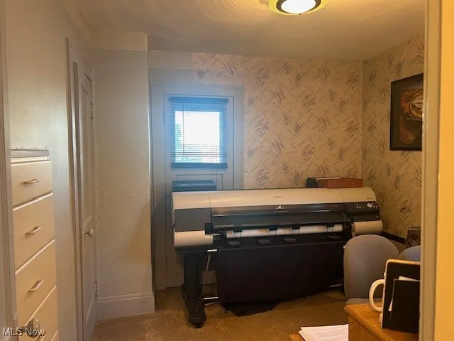Bedroom with attached balcony overlooking backyard.