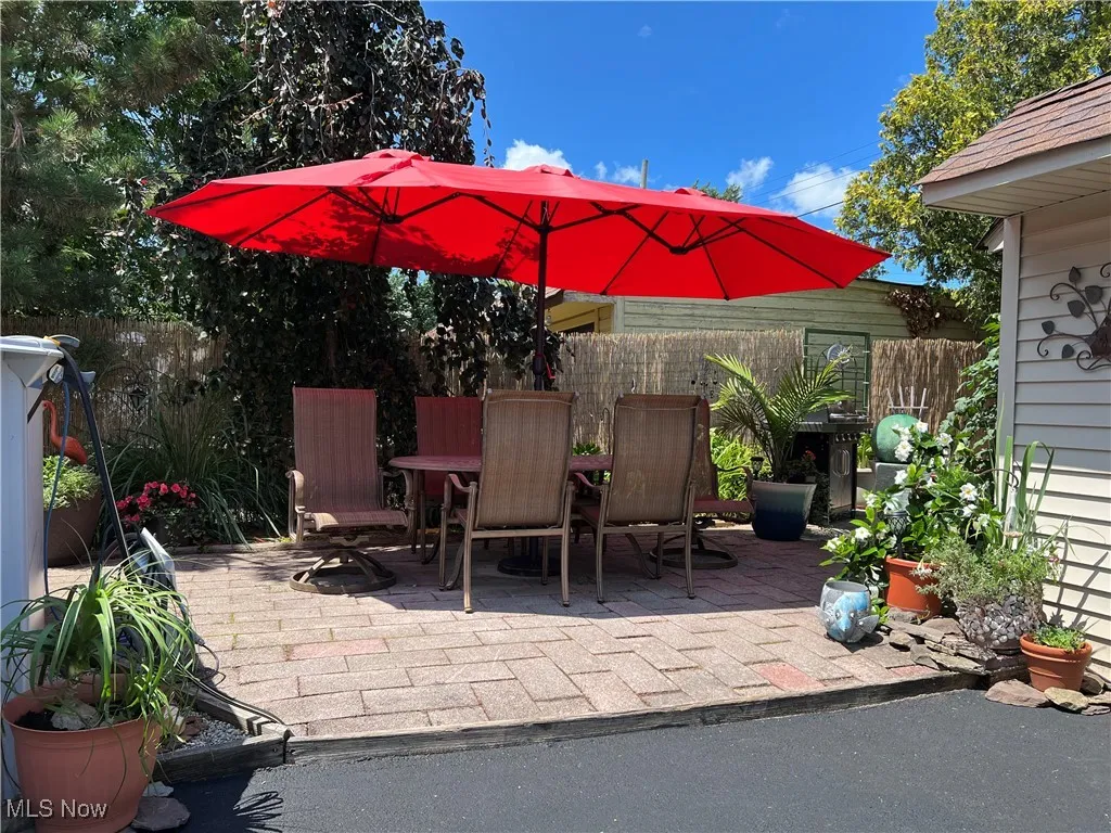 View of bricked patio with outdoor lounging space.