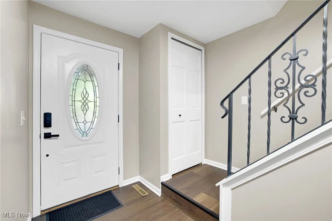 Entrance foyer featuring dark wood-type flooring and stairway