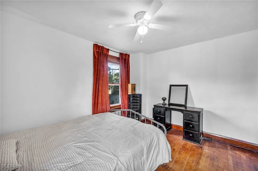 Bedroom with wood-type flooring and ceiling fan