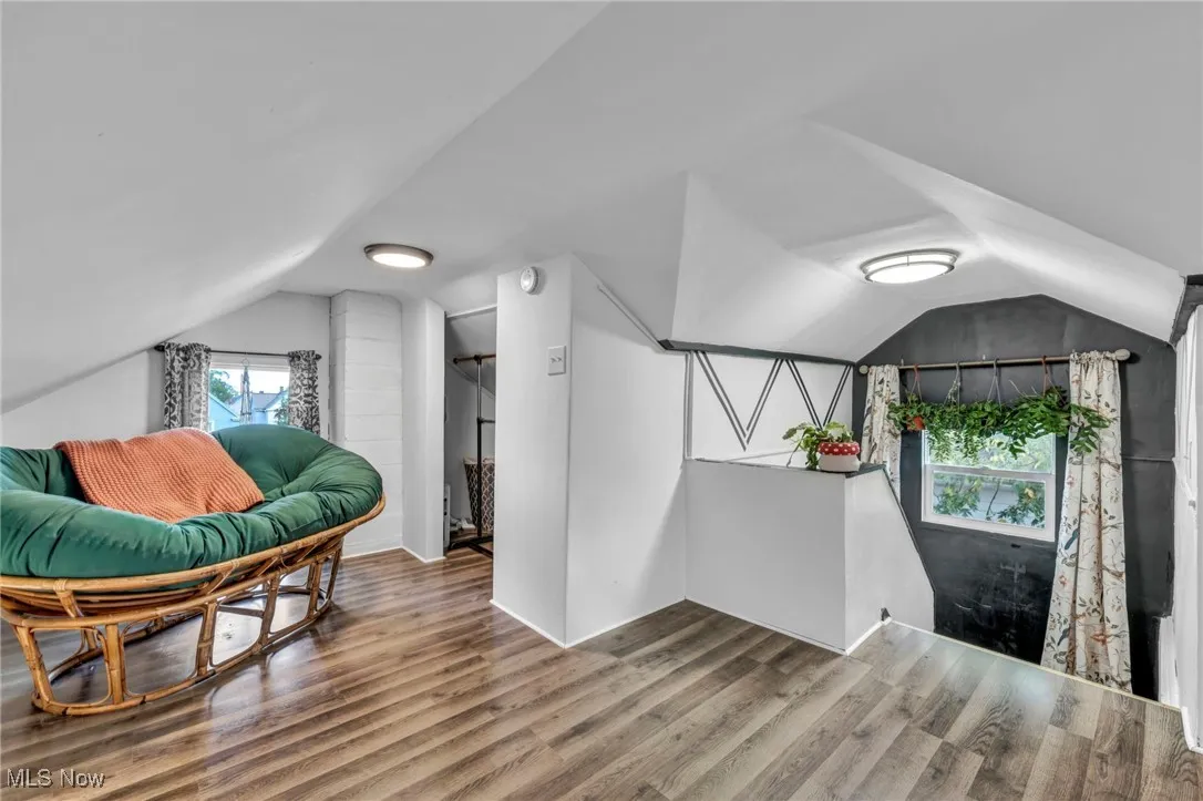Bonus room with vaulted ceiling and wood finished floors