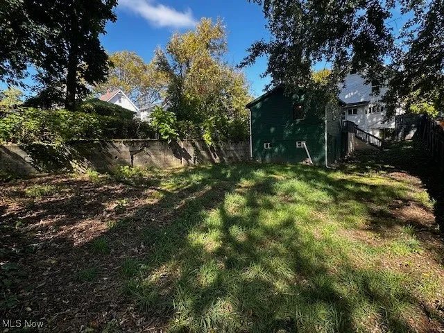 Fenced backyard featuring stairs