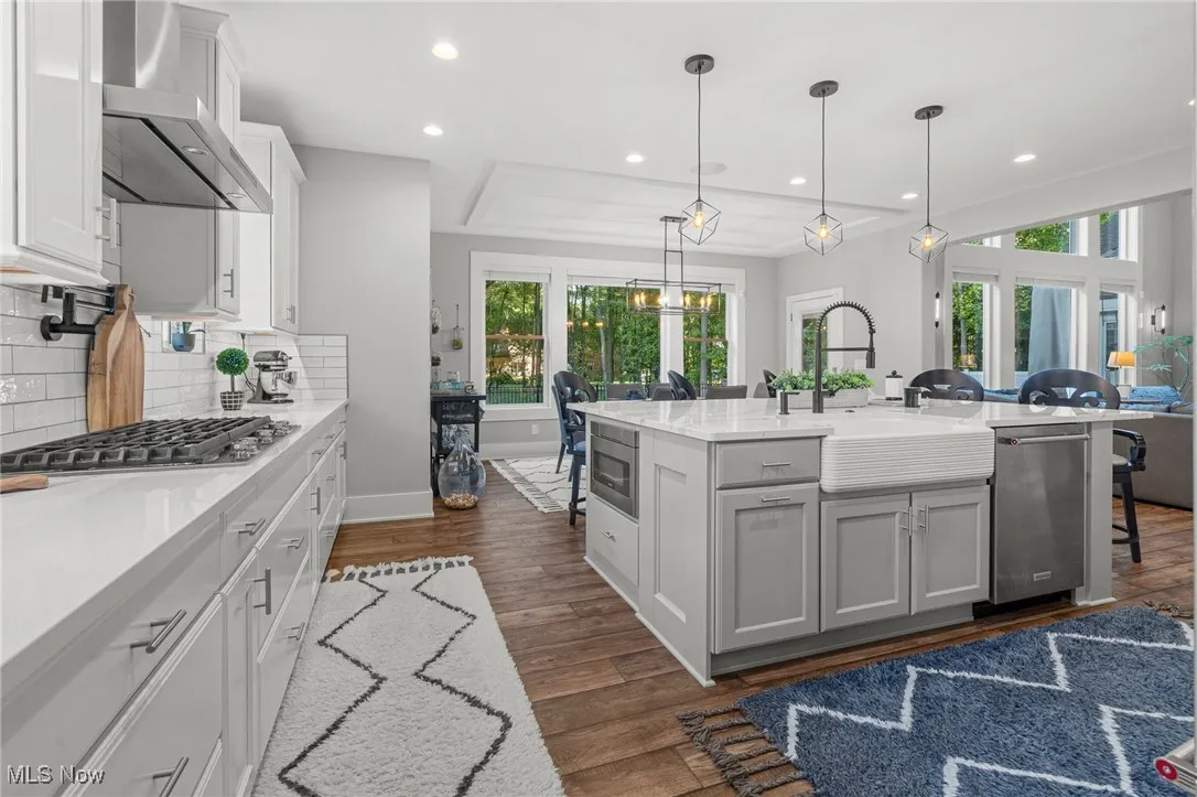 Cambria countertops with tile backsplash from countertop to ceiling