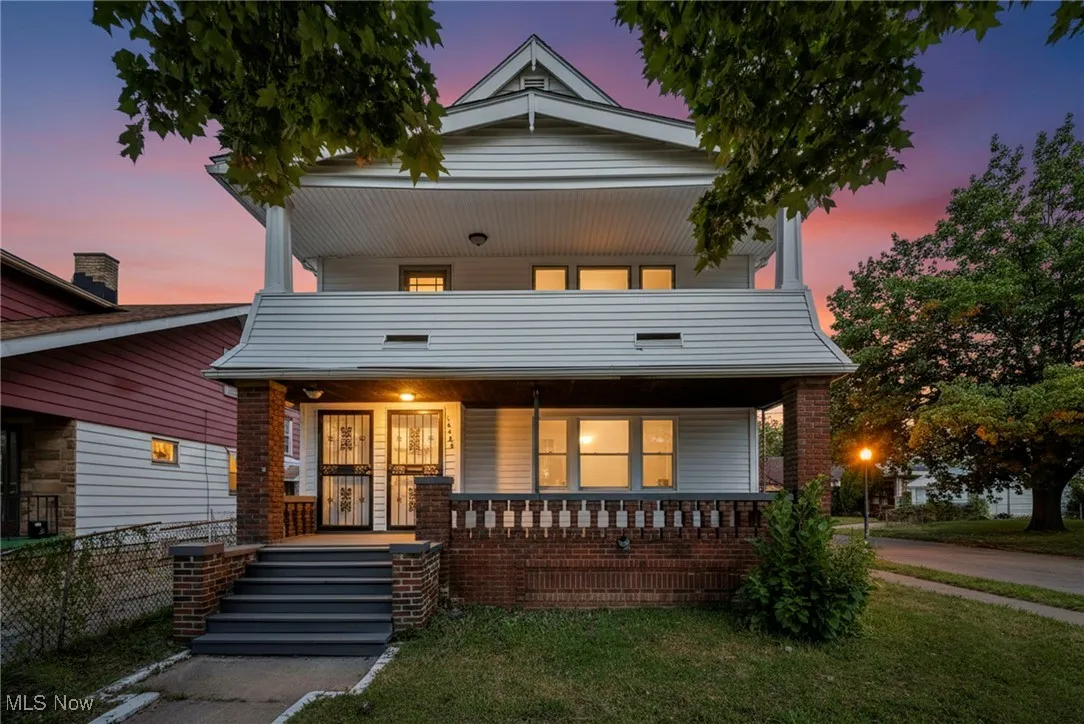 View of front of house featuring covered porch and a yard