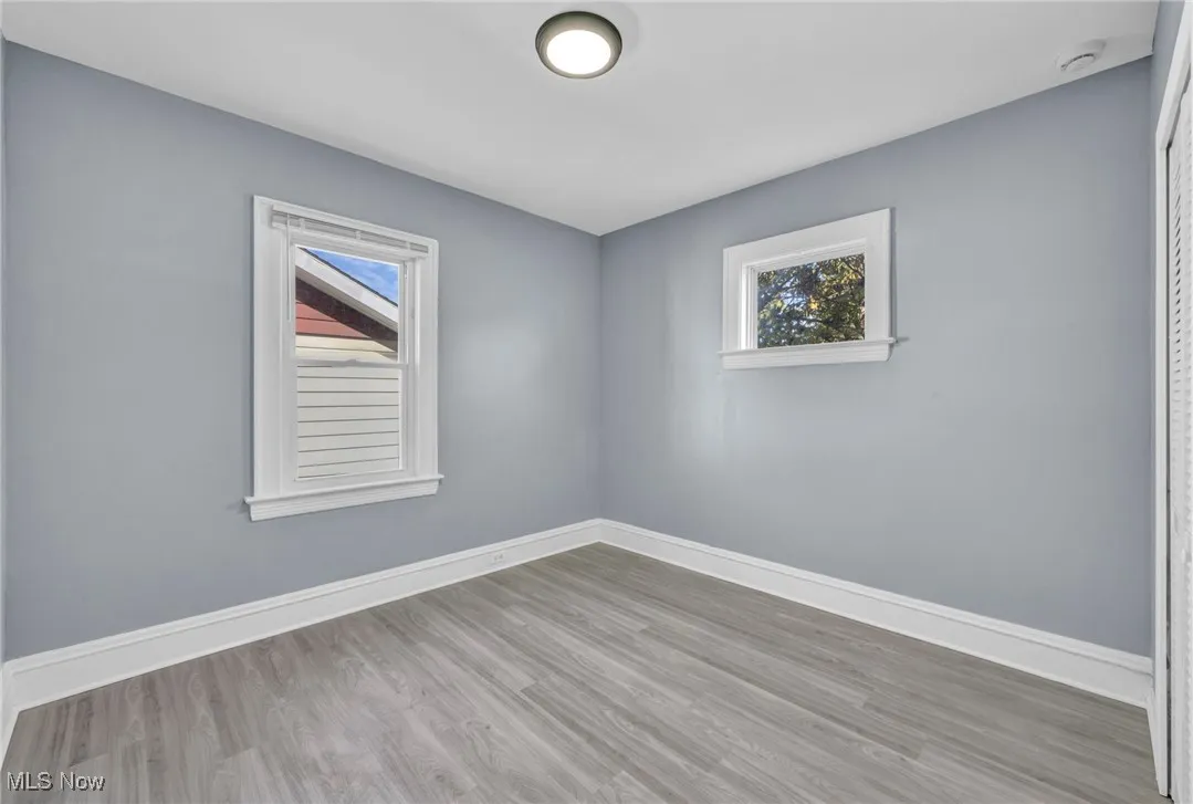 Unfurnished room featuring wood finished floors and​​‌​​​​‌​​‌‌​‌‌​​​‌‌​‌​‌​‌​​​‌​​ baseboards