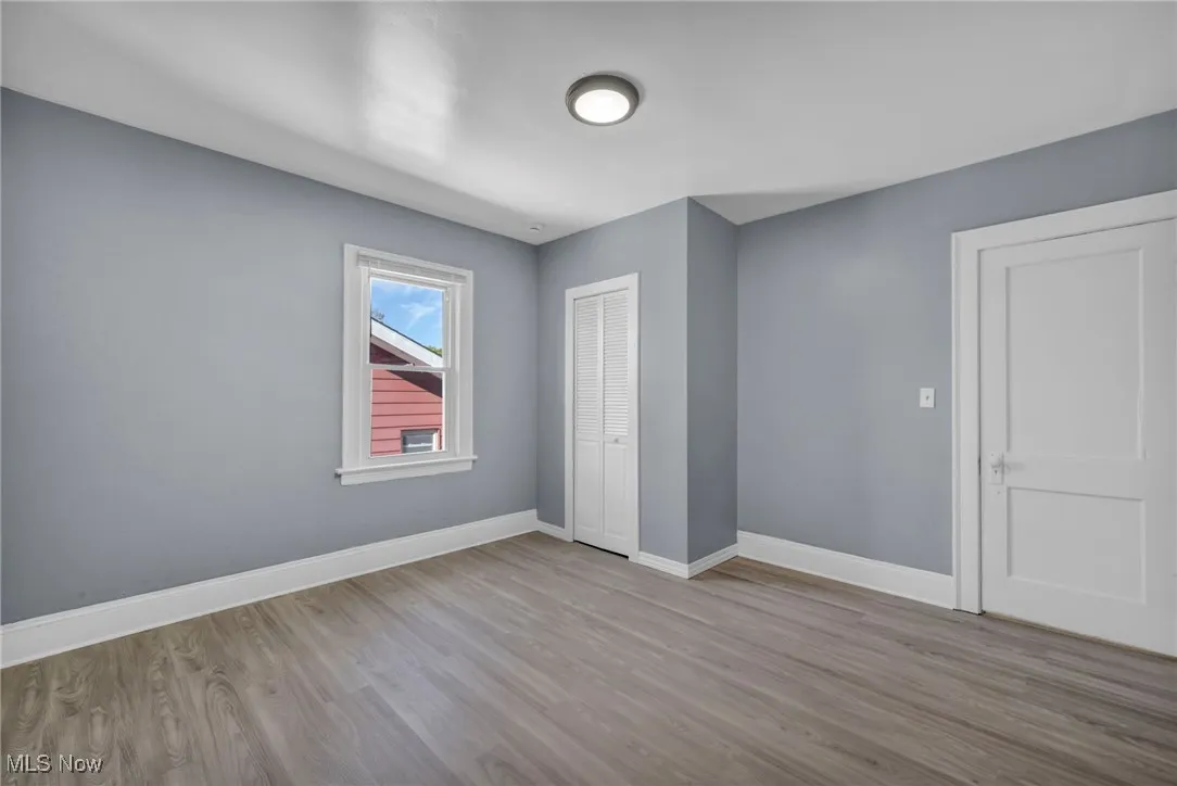 Unfurnished bedroom featuring light wood finished floors and a closet