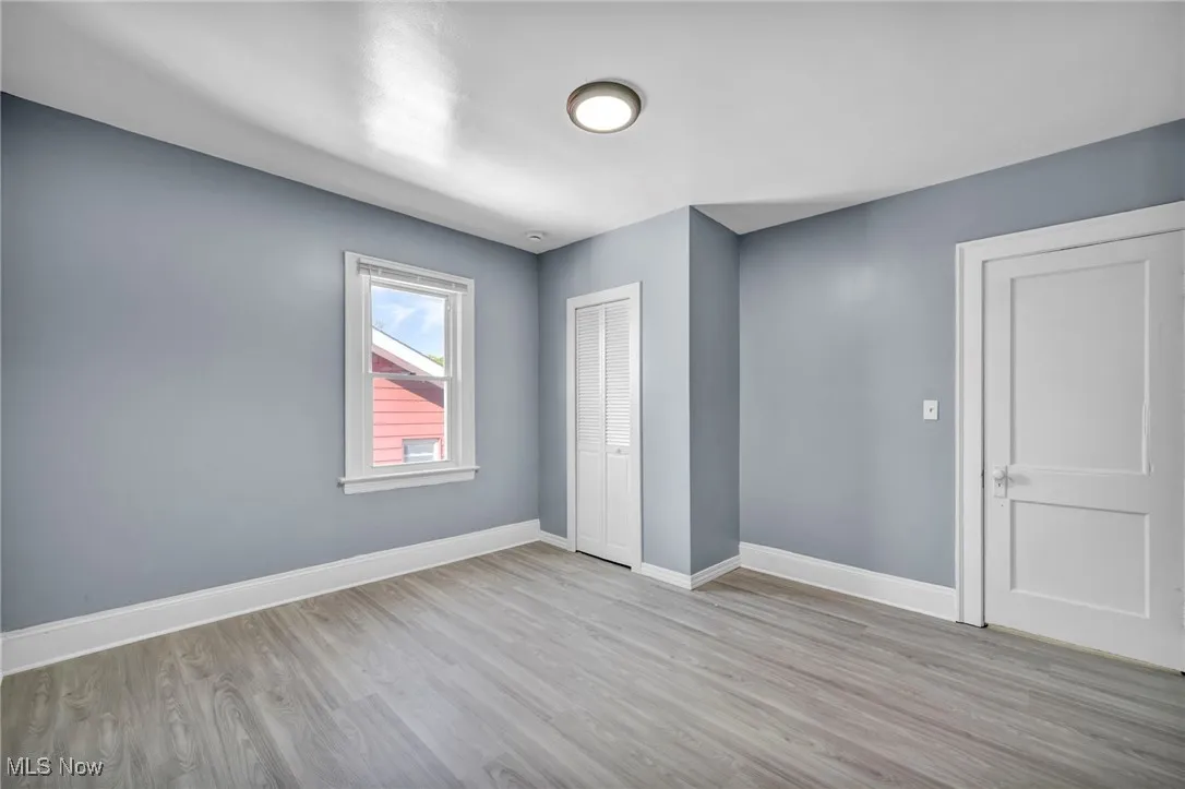Unfurnished bedroom with light wood-style floors and a closet