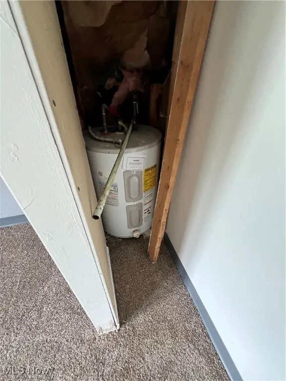 Utility room featuring water heater