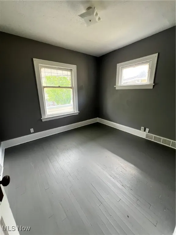 bedroom with hardwood / wood-style floors and a textured ceiling